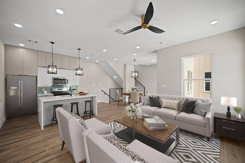 Virtually Staged: Host your next dinner party with confidence! This masterfully-equipped kitchen features a kitchen island, an abundance of new cabinetry, under cabinet lighting, quartz countertops, and stainless-steel appliances.