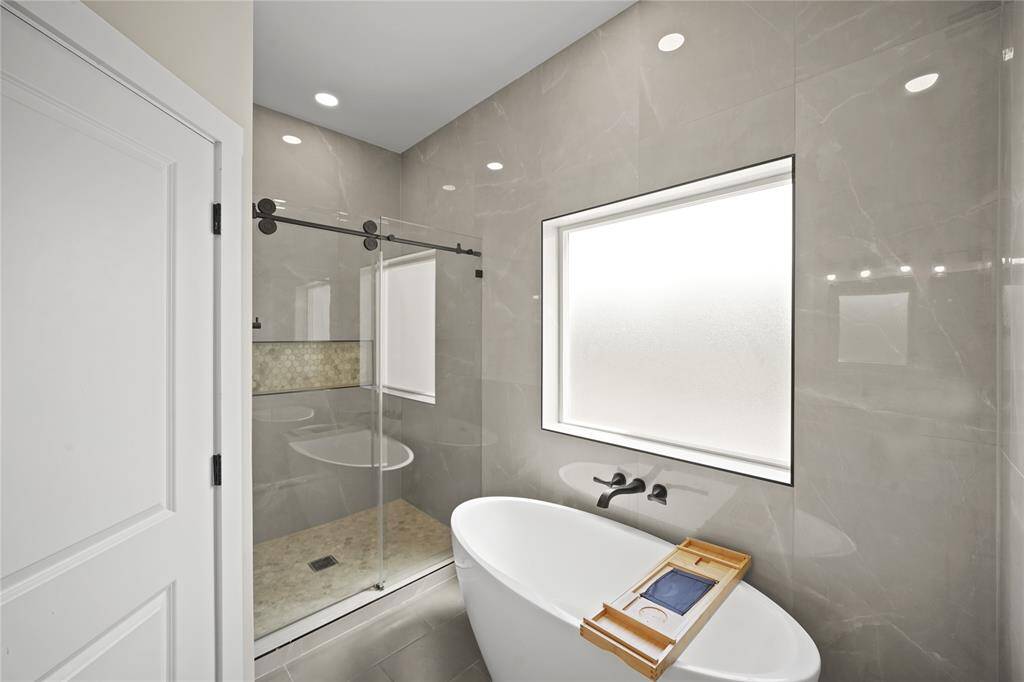 This will be your new favorite place to sit, drink a glass of wine and relax after a long day! This beautiful free standing tub has a large privacy window that lets in plenty of natural light.