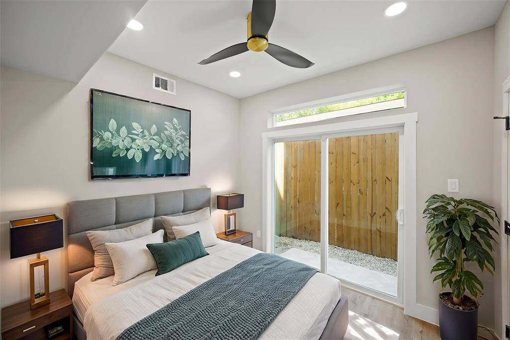 Virtually Staged: This secondary bedroom located on the first floor features recessed lighting, a ceiling fan, and vinyl plank floors.
