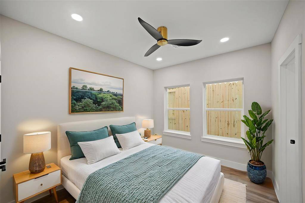Virtually Staged: Secondary bedroom with vinyl plank floors, a built-in closet, a ceiling fan, and recessed lighting.