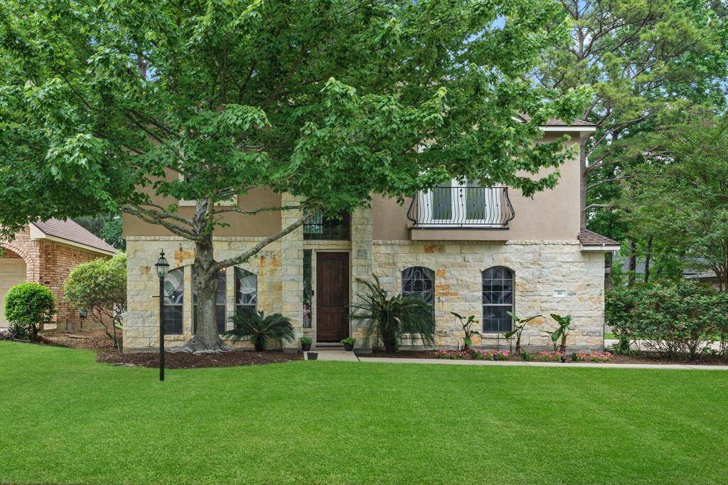 Front of home, large mature maple tree providing shade coverage.