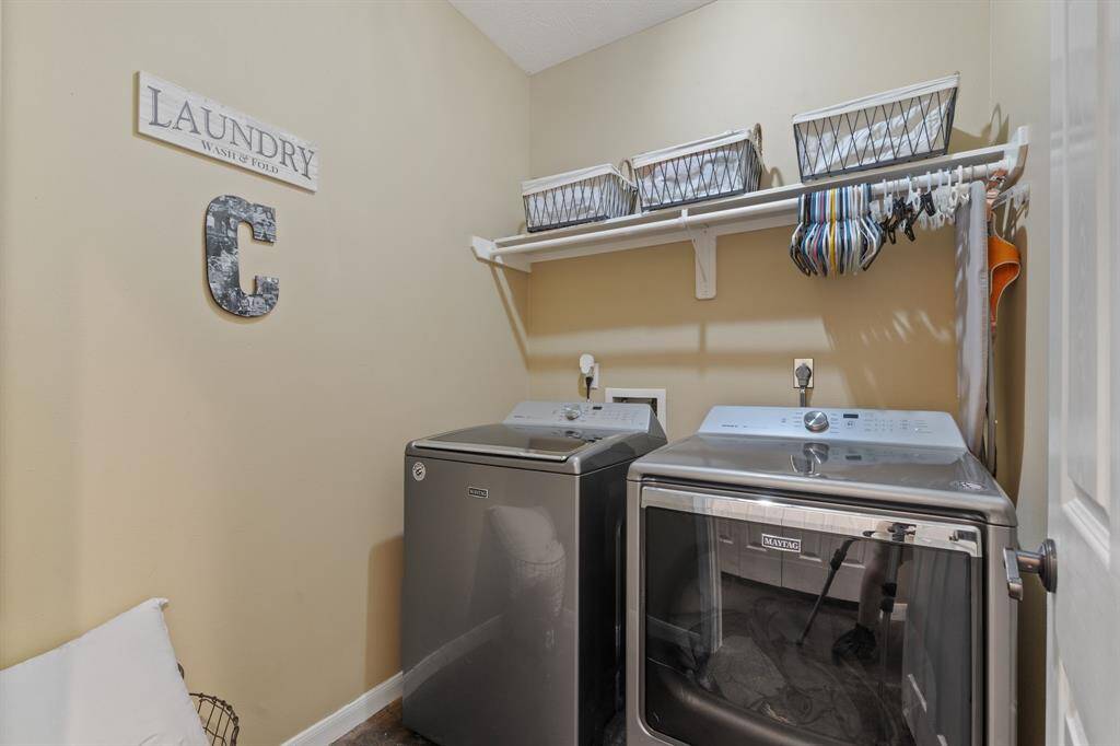 Laundry room w/ built in shelving and hanging rack