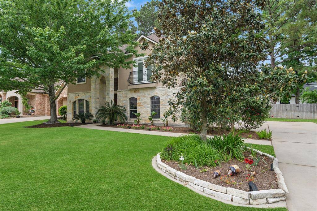 Side profile of front w/ mature magnolia tree *Grass enhanced for visual reference.*