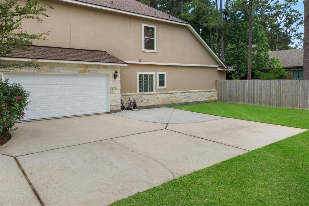 Driveway continued w/ extra parking pad *Grass enhanced for visual reference.*