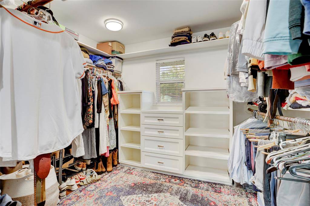 The Primary Closet is larger than average with with bamboo flooring and built-in cabinetry, shelving & shoe racks.