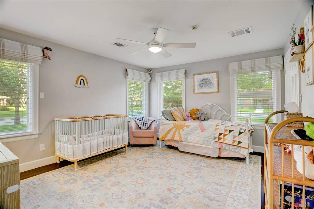 1 of 2 large Secondary Bedrooms with spacious closets, large windows with custom window coverings providing wonderful natural light and bamboo floors.