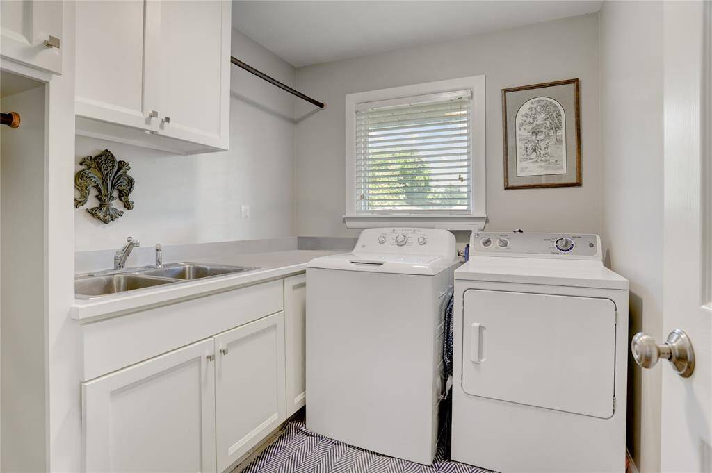 The in-house Utility Room (8’6” x 7') features custom built-in cabinetry with polished nickel hardware, a sink, built-in clothes drying racks and bamboo floors.