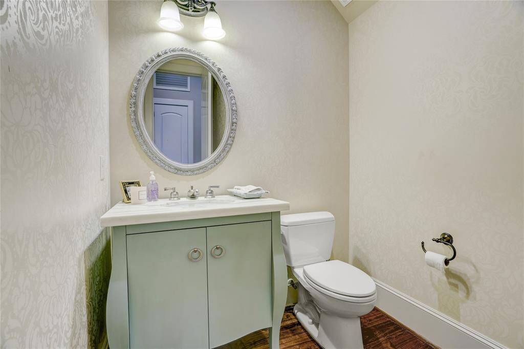 Powder bath conveniently located under the stairs with marble countertops