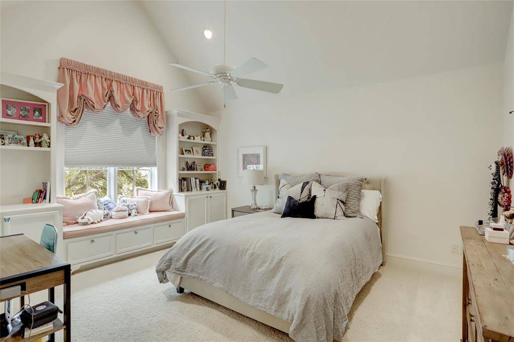 One of the 3 secondary bedrooms featuring vaulted ceiling and window bench