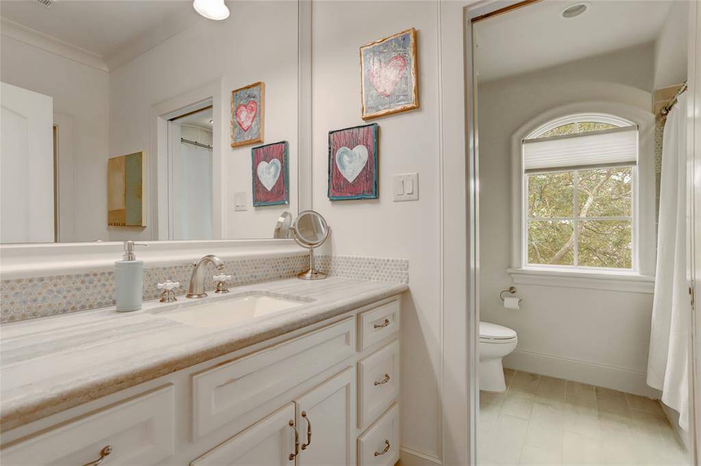 Secondary full bath with marble countertop and separate shower/bath area