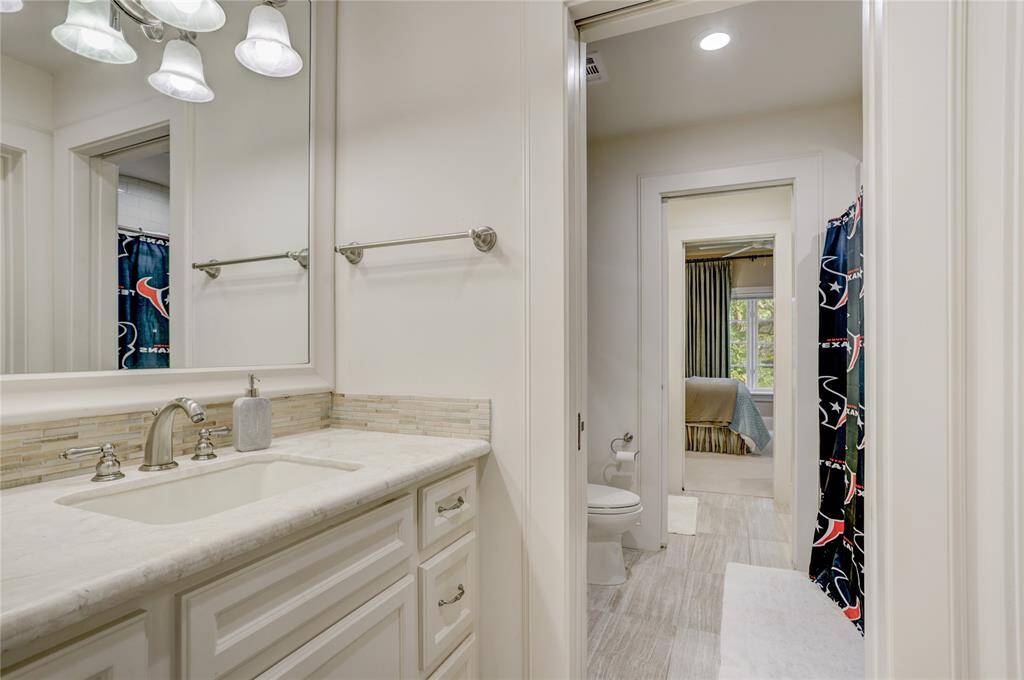 Jack and Jill bathroom with separate since areas and marble countertops