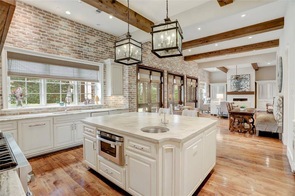 Kitchen looking to the breakfast room and family room with plenty of natural light and entertainment space