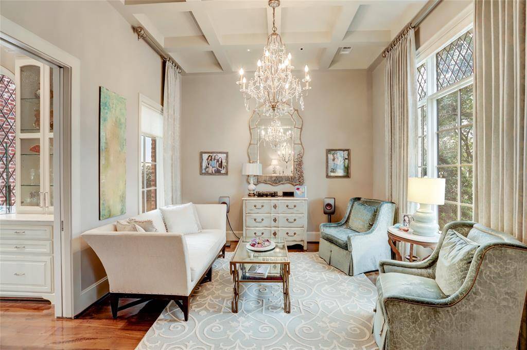 Formal living with coffered ceiling, diamond  windows leading to the wet bar.