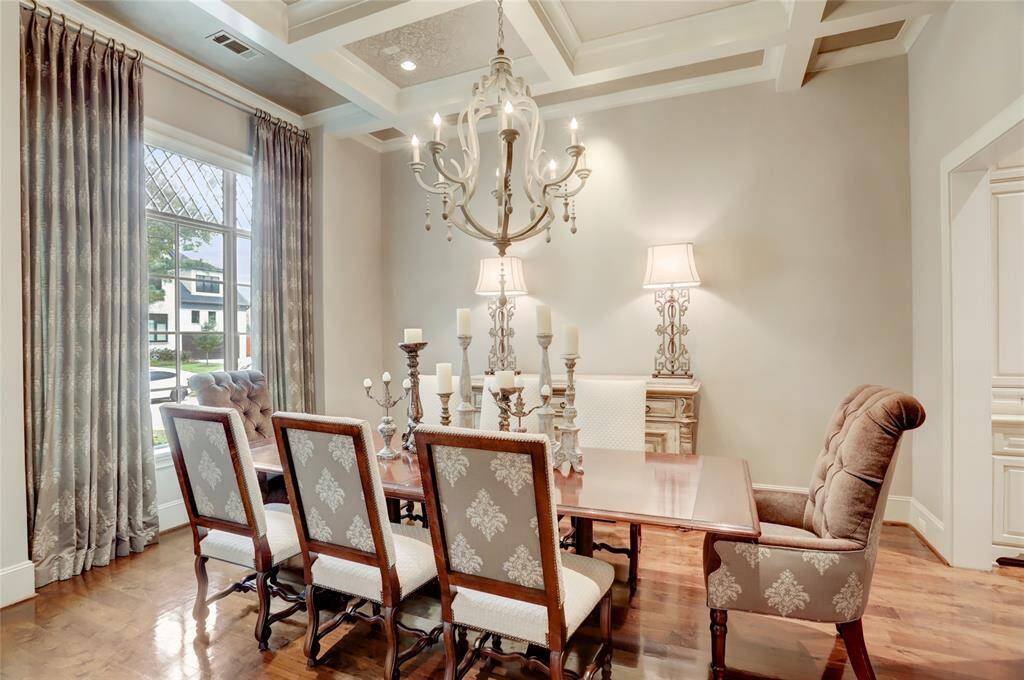 Generous formal dining room with views of the front oak leading to the butler pantry with storage and counter space.