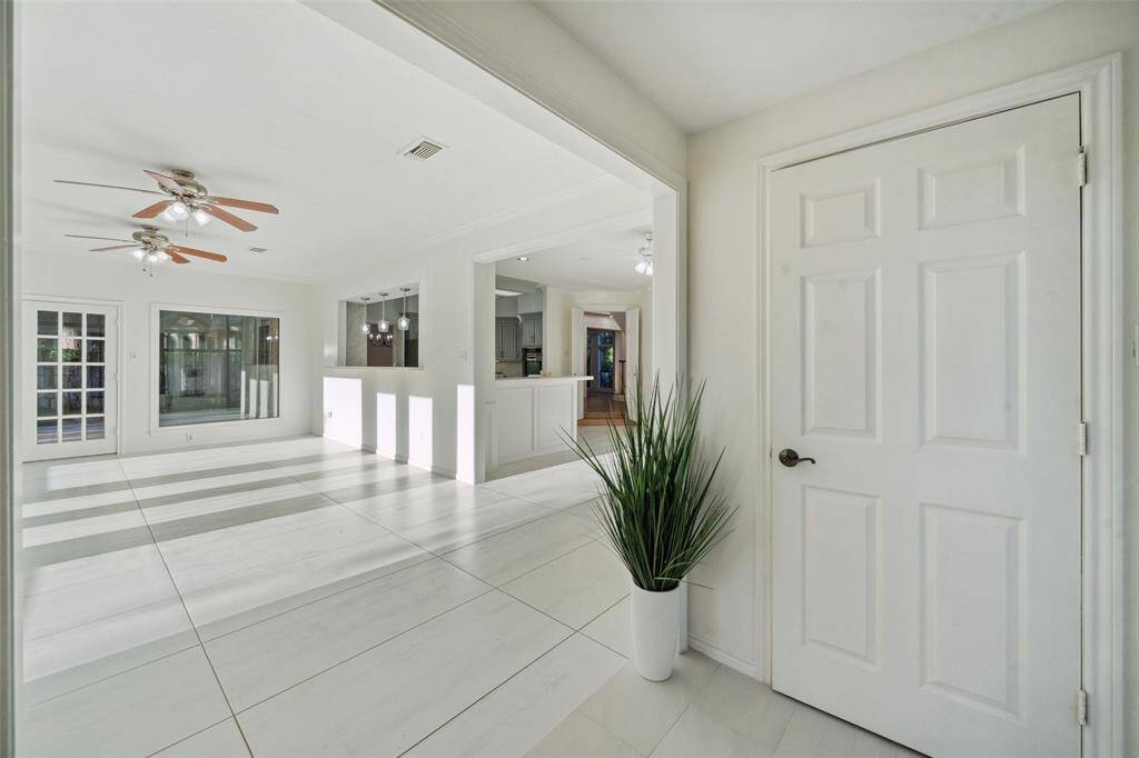 Another view of the spacious family room, showing its adjacency to the modern kitchen