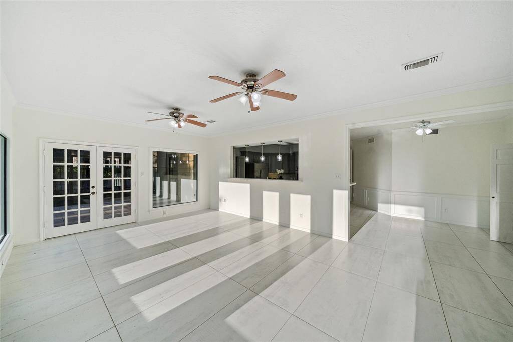 View showcasing the spacious family room and the adjacent breakfast area. The large windows in both spaces allow natural light to flood the rooms, creating a bright and inviting atmosphere.