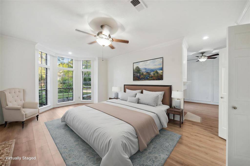 spacious master bedroom designed for comfort and relaxation, featuring large windows that allow natural light to fill the room.