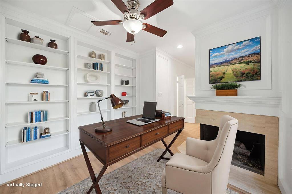 Inviting office or reading nook adjacent to the master bedroom, featuring its own cozy fireplace.