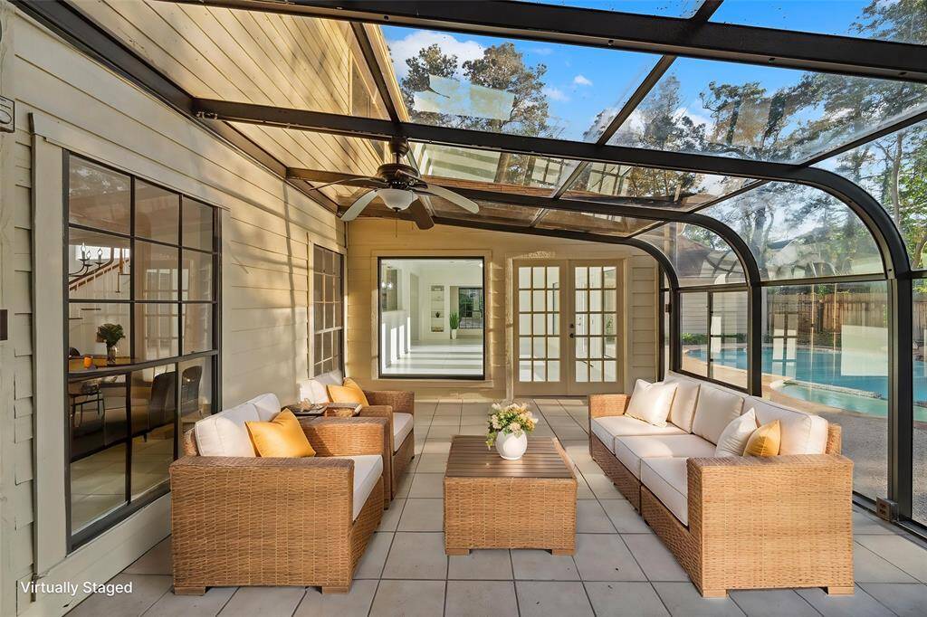 Bright sunroom equipped with a working AC, providing a comfortable space to relax and enjoy the natural light.