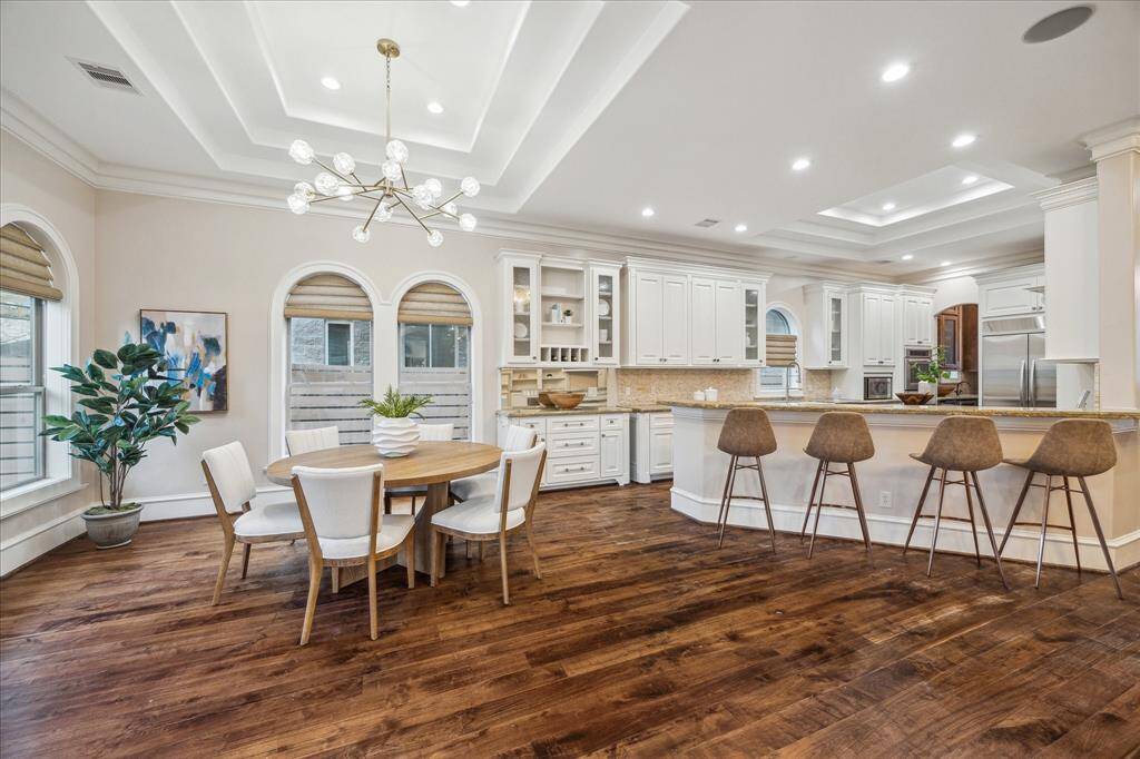 An expansive breakfast bar offers additional seating and/or serving counter.