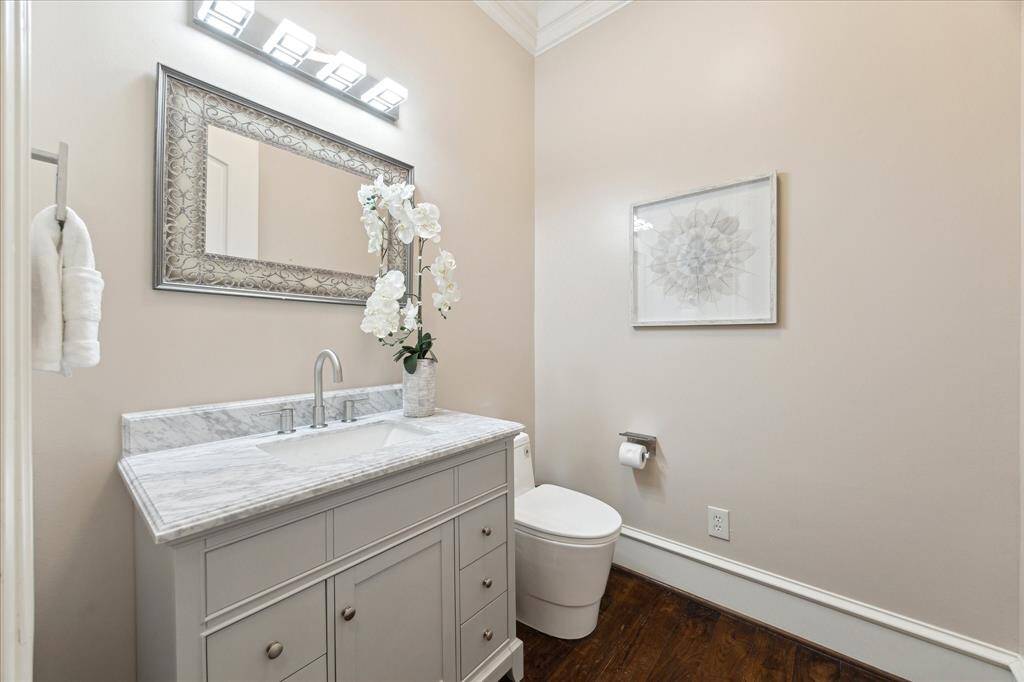 Updated in 2024, the first-floor powder room features a classic marble counter and undermount sink.