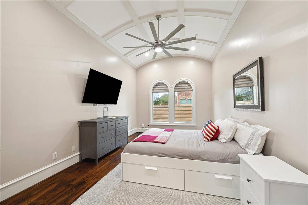 With a dramatic ceiling and en-suite bath, the main-level secondary bedroom creates private, comfortable quarters for guests or in-laws.