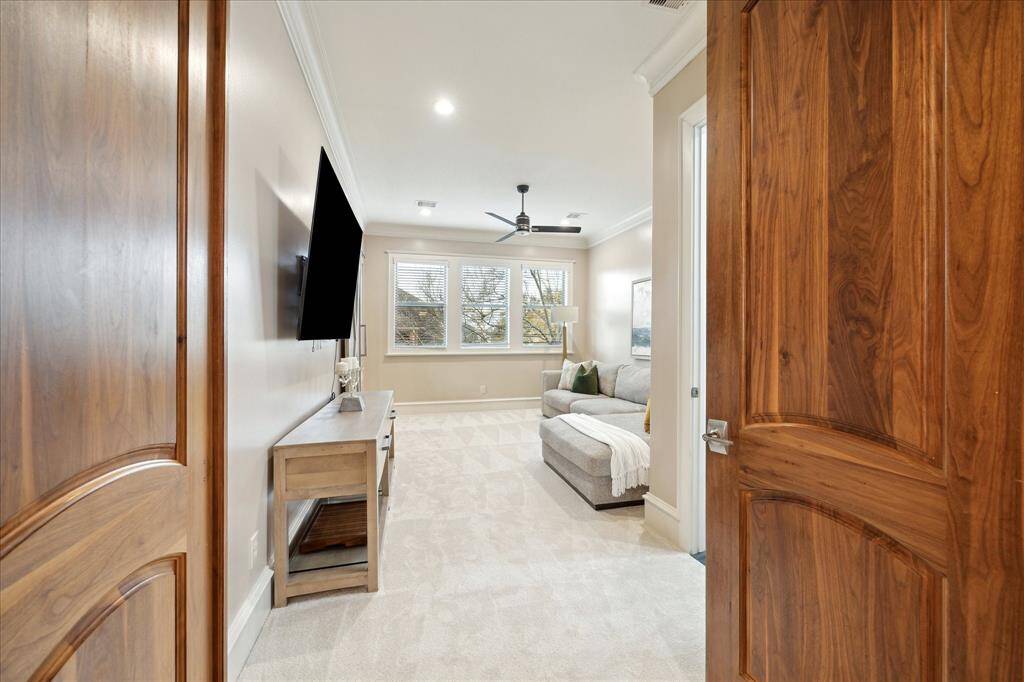Enter the primary suite through the flexible-use space; while currently used as a sitting room, this could also serve as a nursery, private office, or adjacent secondary bedroom.