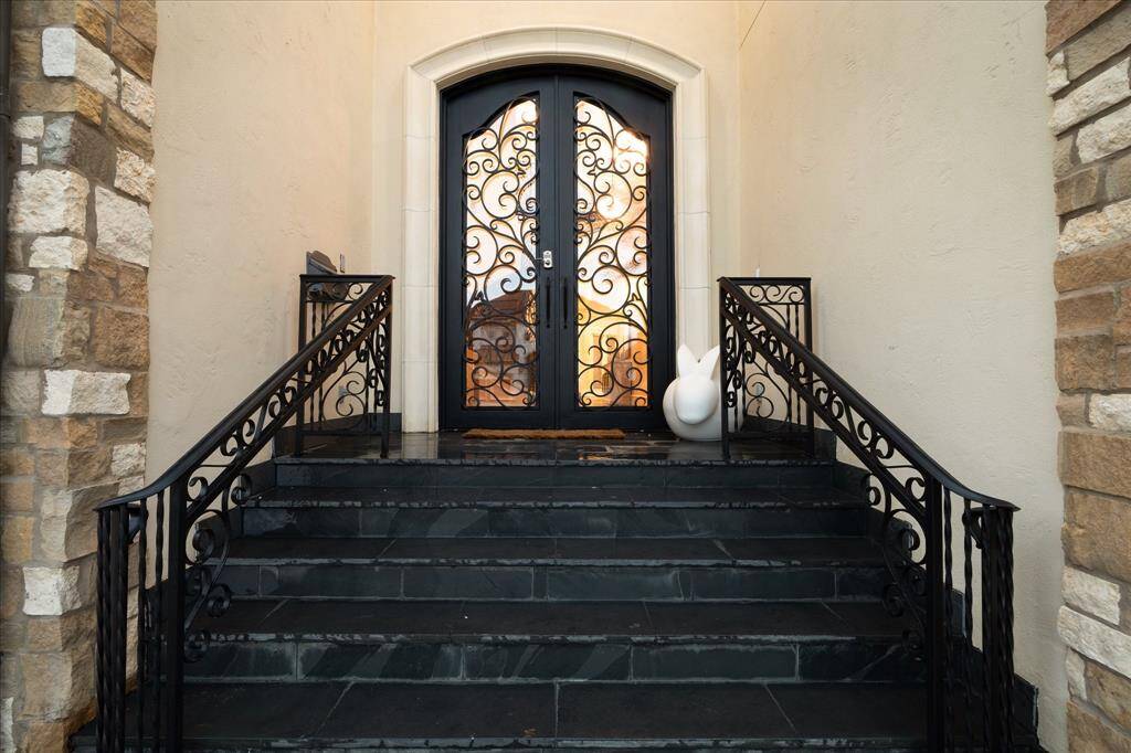 Classic architectural elements include an elevated entrance and limestone surround.