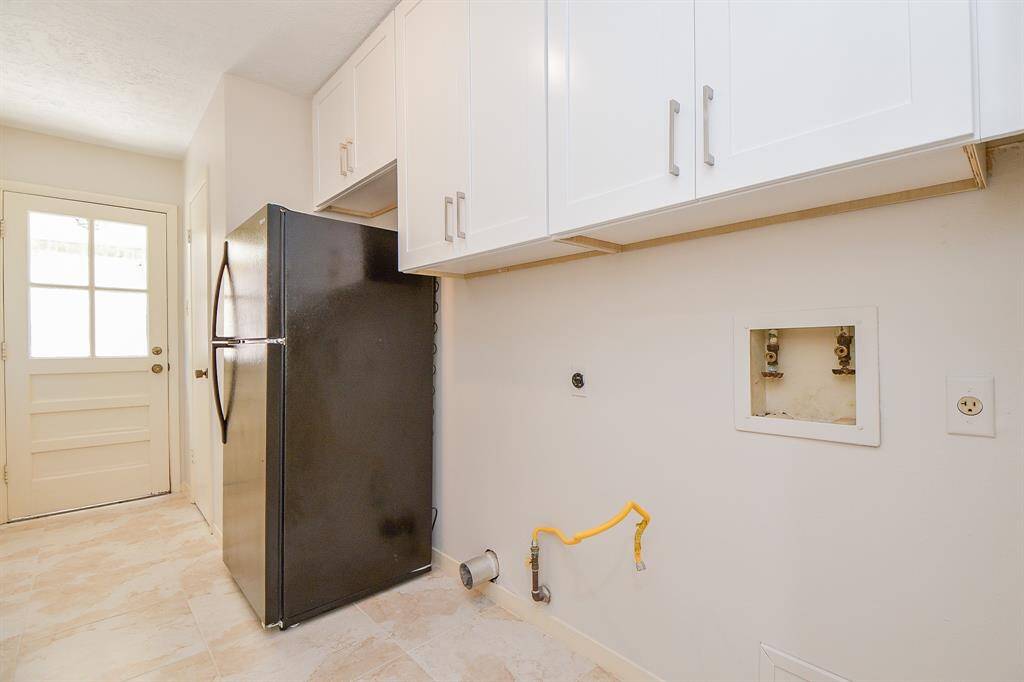 Huge utility room with all new cabinets and tile flooring