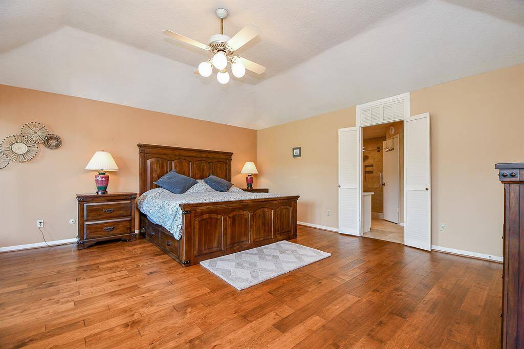 Huge Primary Bedroom with a view of the pool and creek