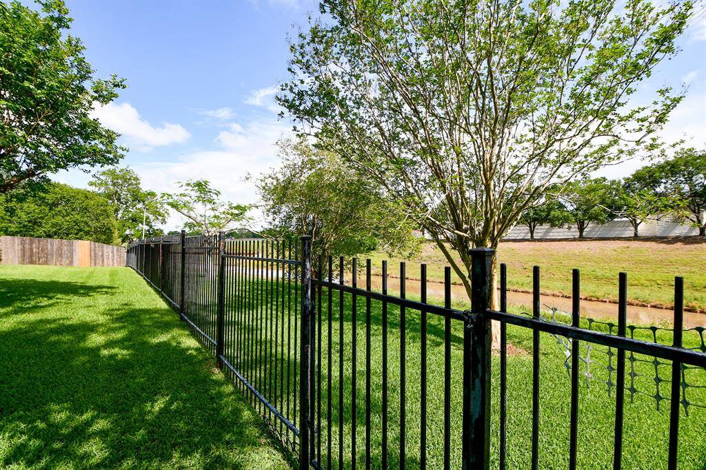Property backs up to the creek with iron fencing.