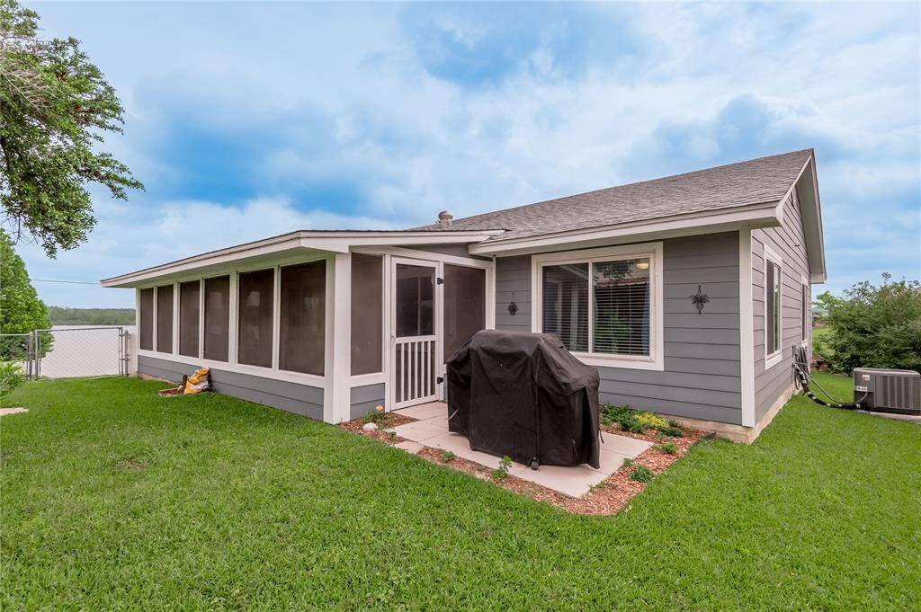 Enclosed porch opens to pad area perfect for your BBQ Grill or Firepit.