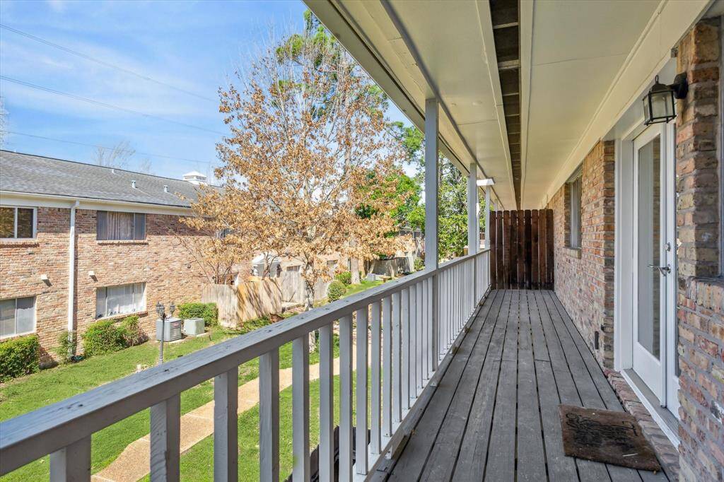 Balcony off kitchen overlooks lovely green space.