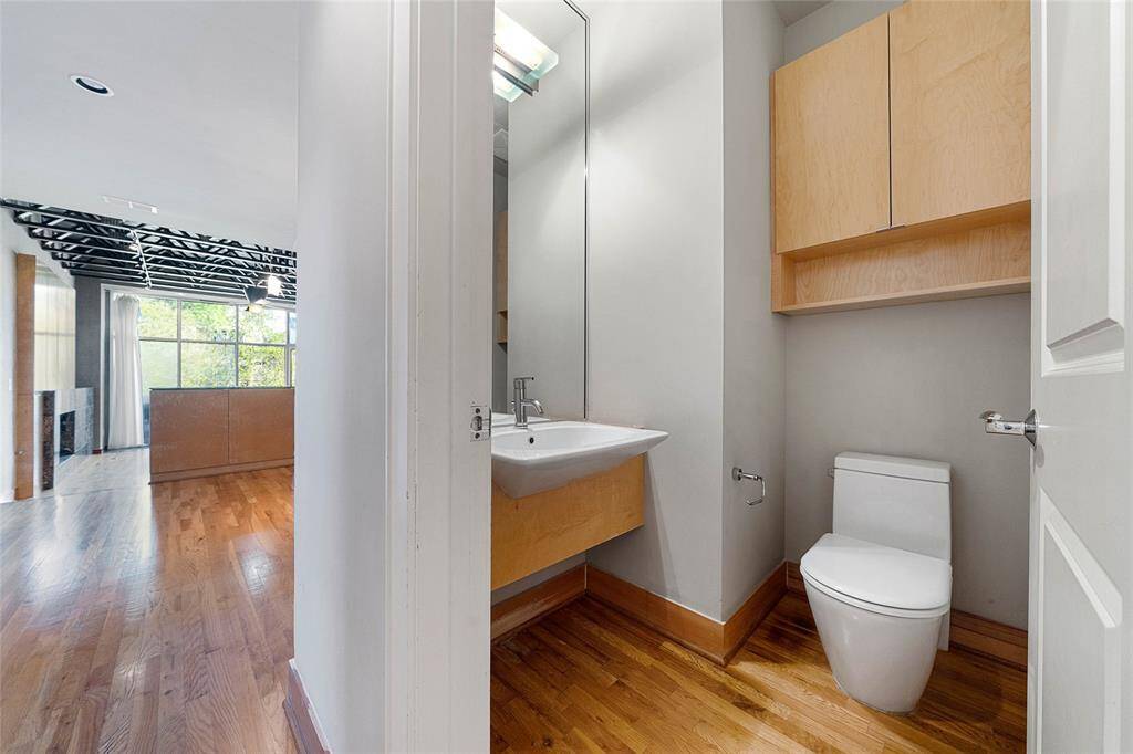 Powder Room on the 2nd Level withmodern cabinetry, wood floors
