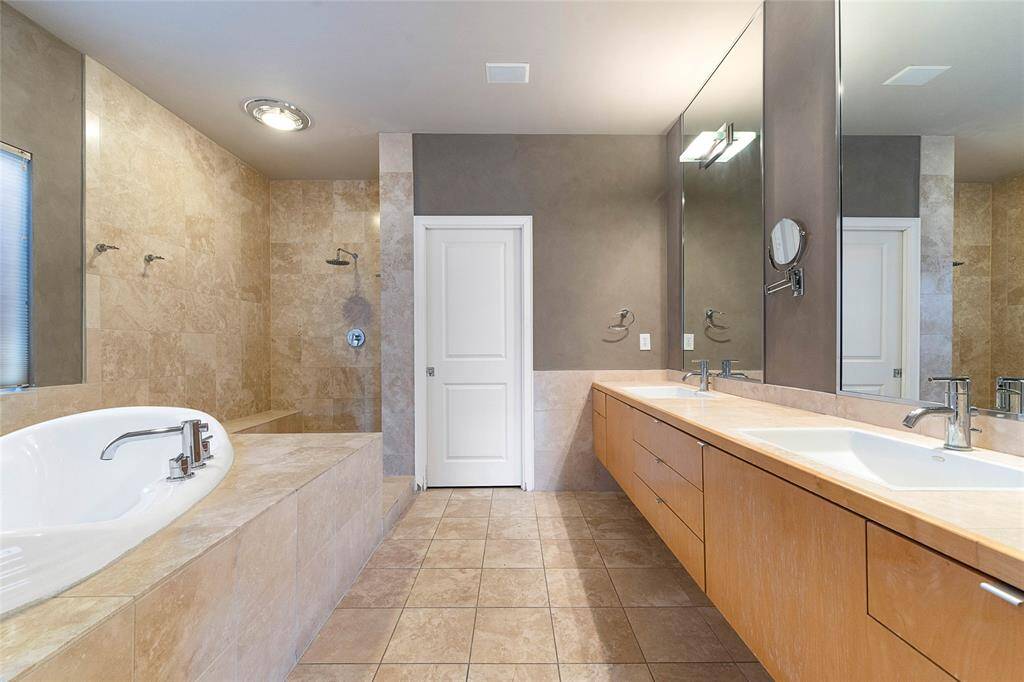 Primary Bath on 3rd Level (approx.12x13) features double sinks, travertinetile, spa-like walk in shower, oversizedsoaking tub.