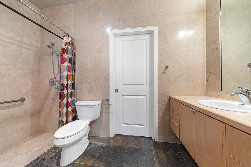 1st Level Full Bath (approx. 10x5)w/travertine and slate tile, walk-inshower, and access from 1st levelbedroom and flex/gameroom.