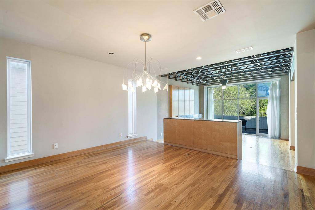 Dining (approx. 15x13) to living area,oak hardwood floors, modernchandelier, open floorplan.
