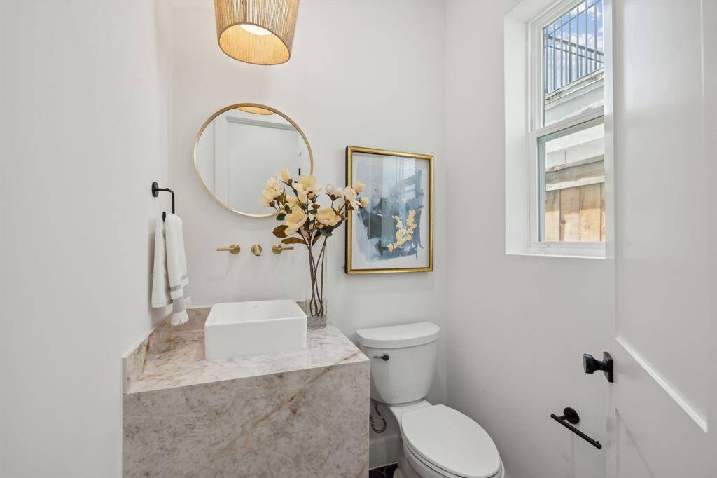 First floor powder room offers statement vanity and lighting.