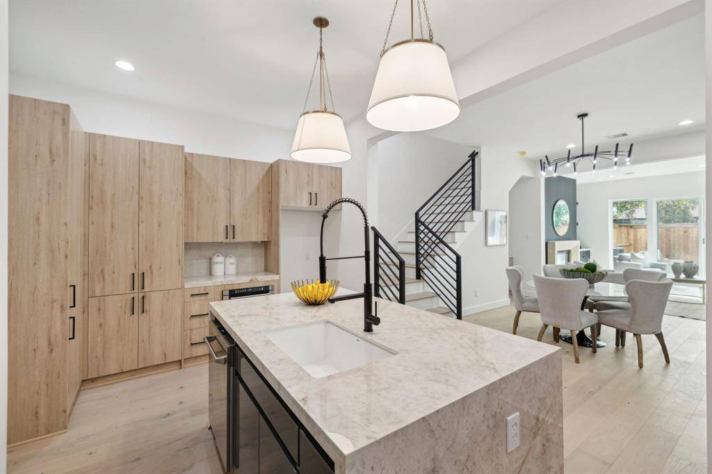 Custom cabinetry adds texture and warmth to the clean aesthetic.