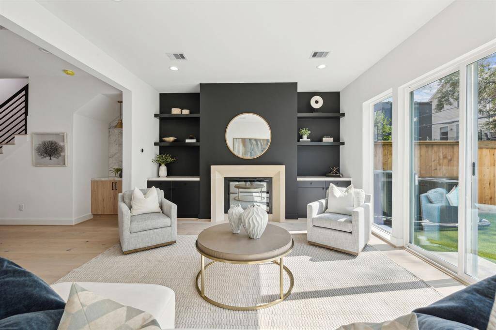 Floor-to-ceiling windows flood the living space with sunlight.
