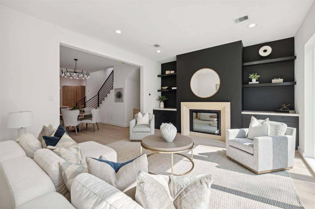 The cast stone fireplace surround and built in shelving offer both warmth and architectural interest.