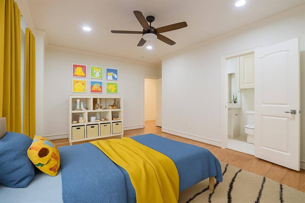 Virtually staged, this room features hardwood floors, a ceiling fan, and recessed lighting. It includes an en-suite bathroom with a modern design, offering both functionality and style.