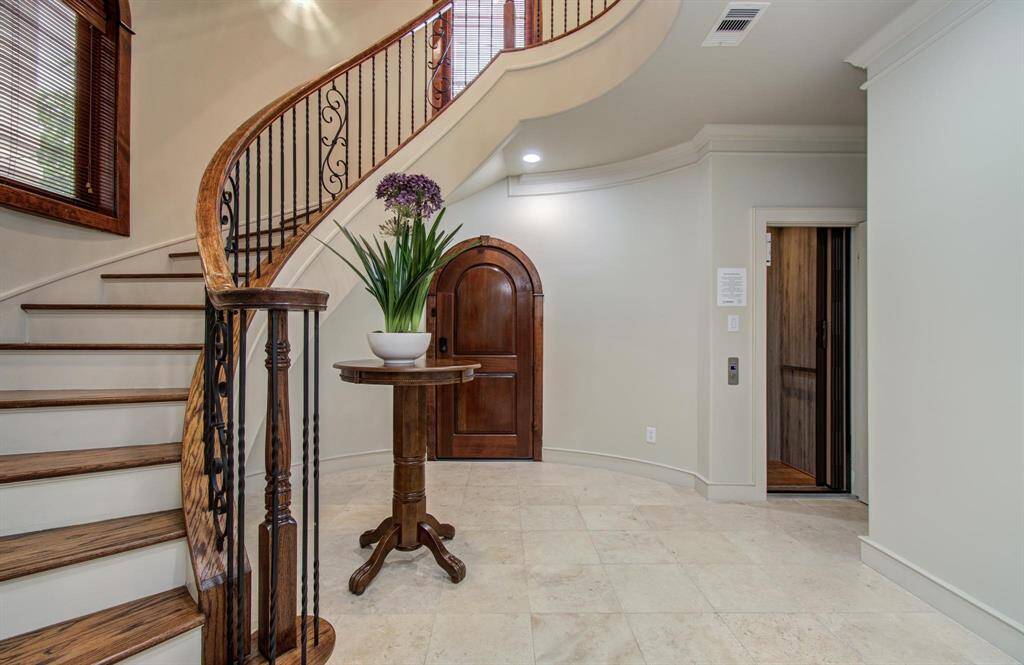 The foyer with. the striking stairwell. View of the elevator