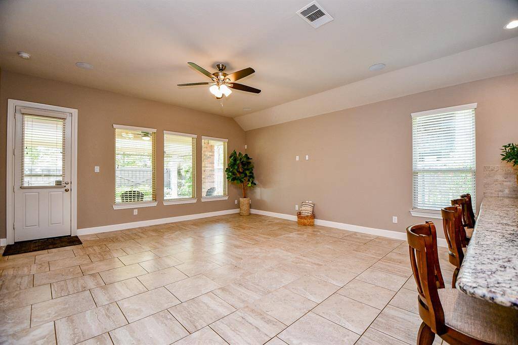 Large living room open to kitchen and foyer.