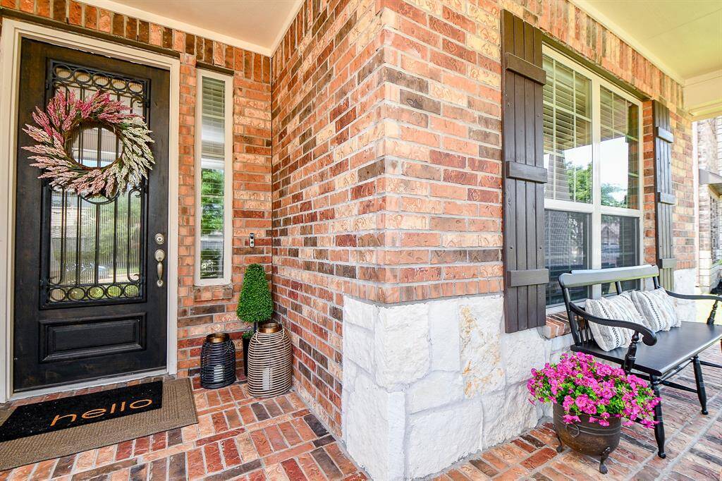Charming brick entry and front patio. Take a seat, wave to your neighbors.