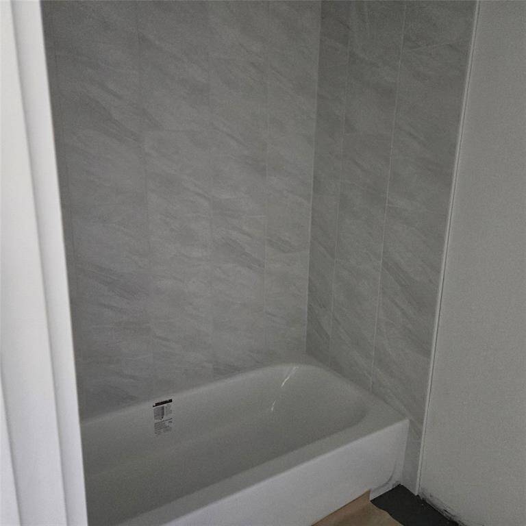 *ACTUAL PHOTO (under construction) - Bath #2 upstairs with tile surround*