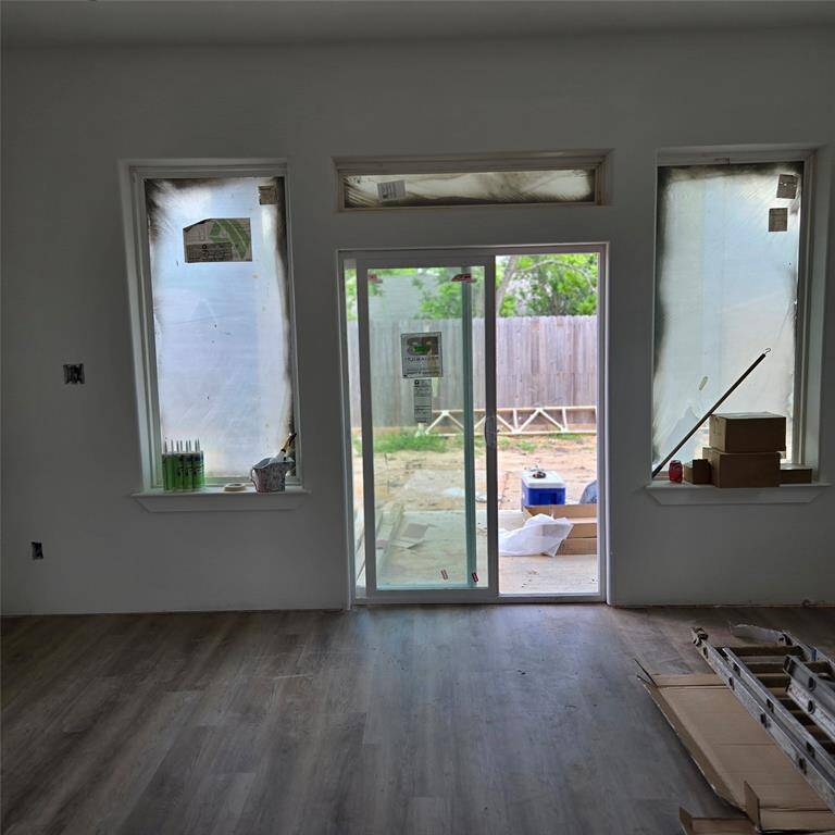 *ACTUAL PHOTO (under construction) - sliding glass doors lead to a covered patio*