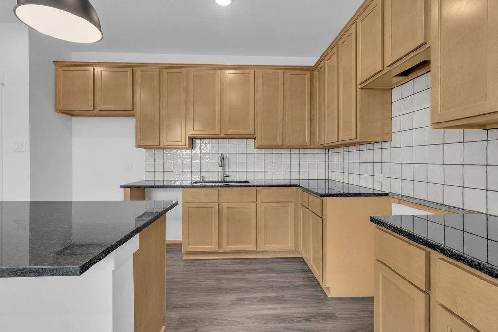 This beautiful brand new kitchen boasts stunning cabinetry that stretches to the ceiling, offering both style and ample storage for all your culinary treasures.