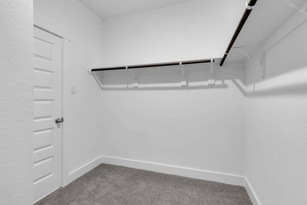 A stylish walk-in closet awaits, providing ample storage for your wardrobe and a little extra room for those cherished items.