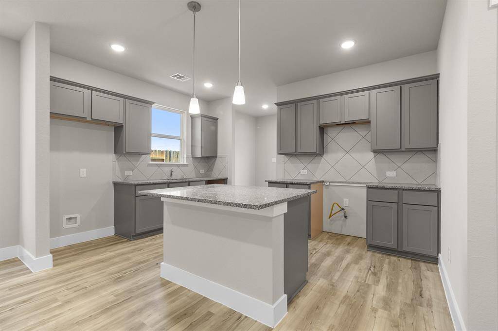 This kitchen isn’t just a place to cook; it’s a space where memories are made, where family traditions thrive, and where you can feel truly at home. Microwave, Dishwasher, Stovetop range are included, just not pictured.